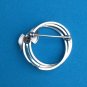 VINTAGE STERLING SILVER TRIPLE CIRCLE WITH BOW PIN. SIGNED "d e c "