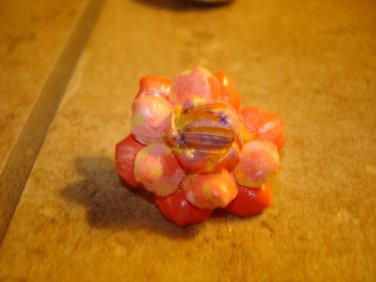 Delicate plastic button in shape of flower.