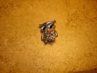 Cute silver metal button in shape of owl with colorful rhinestones.
