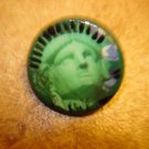 Old metal button with Statue of Liberty head.