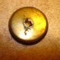 Old metal button with Statue of Liberty head.