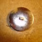 Large silver metal button with Noah's arc and black beads.