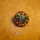 Gold metal button with dragonfly with green wings.