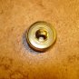 Gold metal button with dragonfly with green wings.