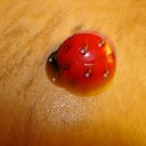 Plastic button in shape of lady bug.