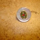 Vintage mother of pearl button with tiny red rhinestone.