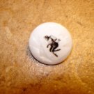 Mother of pearl button with black devil picture.