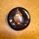 Large black plastic button with tropical bird.