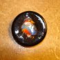 Large black plastic button with tropical bird.