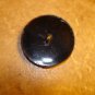 Large black plastic button with tropical bird.