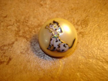 Dome shape plastic button with sitting dog.