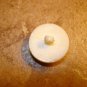 Dome shape plastic button with sitting dog.