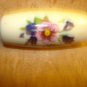 Large plastic oblong button with flowers.