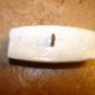 Large plastic oblong button with flowers.