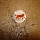 Mother of pearl button with red horse. Mother of pearl button with red horse.