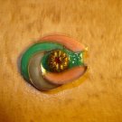 Oval shape metal button with red rhinestone.