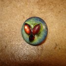 Glass button with tier shape glass beads & small garnet.