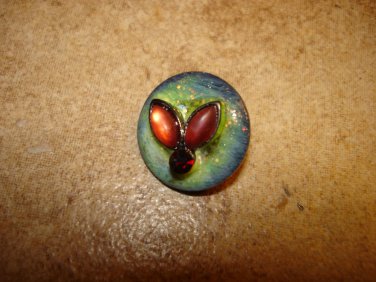 Glass button with tier shape glass beads & small garnet.