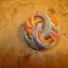 Pierced plastic colorfully painted button. Pierced plastic colorfully painted button.