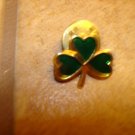 Gold metal pinback pin with green shamrock leaf. Gold metal pinback pin with green shamrock leaf.