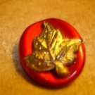 Beautiful large oval button with gold metal leaf.