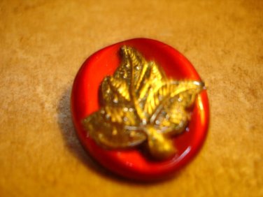 Beautiful large oval button with gold metal leaf.