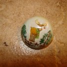 Dome shape Christmas button with moose and Christmas tree.