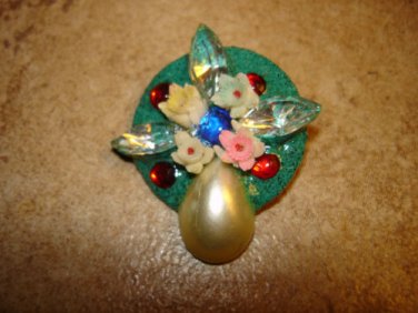 Signed metal button with glass beads, pearl, flowers and rhinestones.