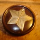 Large plastic button with metal star and tiny rhinestone.