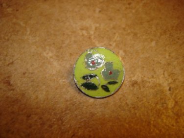 Signed silver metal button with green flower.