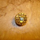 Vintage gold metal button with beautiful glass bead.