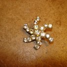 Silver metal button in shape of snowflake with white rhinestones. Silver metal button in shape of snowflake with white rhinestones.