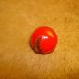 Old red glass button with gold leaf.
