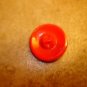Old red glass button with gold leaf.