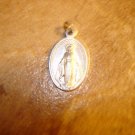 Silver metal religion catholic pendant with St. Mary.
