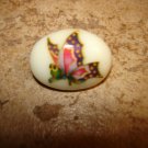 Oval shape ceramic button with colorful butterfly.