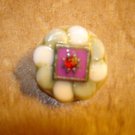 White plastic button with red rhinestone. White plastic button with red rhinestone.