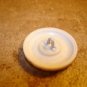 White plastic button with metal cowboy hat