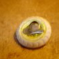 White plastic button with metal cowboy hat