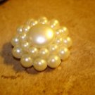 Large button with white pearls and metal back.