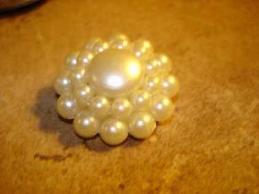 Large button with white pearls and metal back.