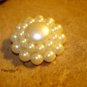 Large button with white pearls and metal back.