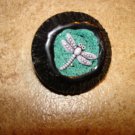 Black hard plastic button with dragonfly. Black hard plastic button with dragonfly.