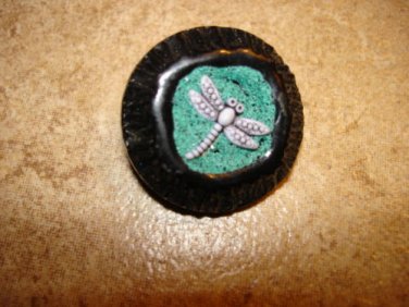 Black hard plastic button with dragonfly.