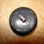 Black hard plastic button with dragonfly.