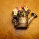 Pewter button in shape of watering can with flowers. Pewter button in shape of watering can with flowers.