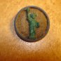 Metal button with Statue of Liberty.