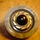 Large plastic button with black glass bead.