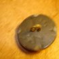 Large plastic button with black glass bead.