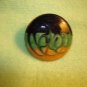 Large art nouveau style yellow, green black metal button.